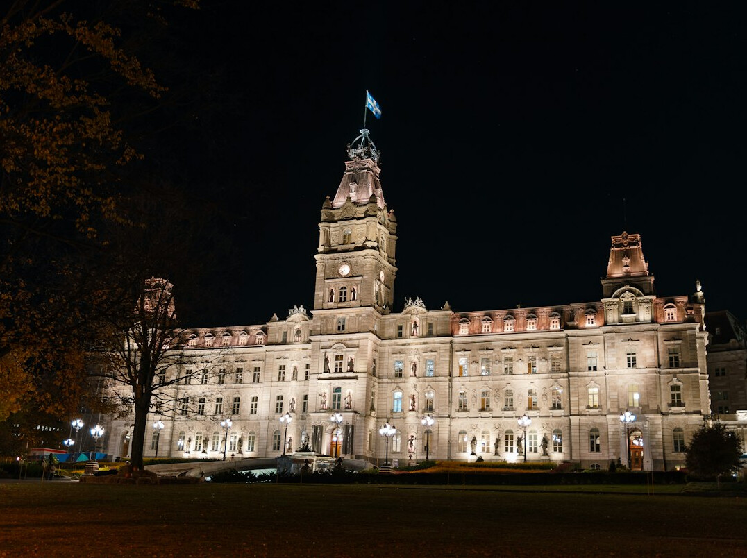 Canadian parliament building exterior with flag